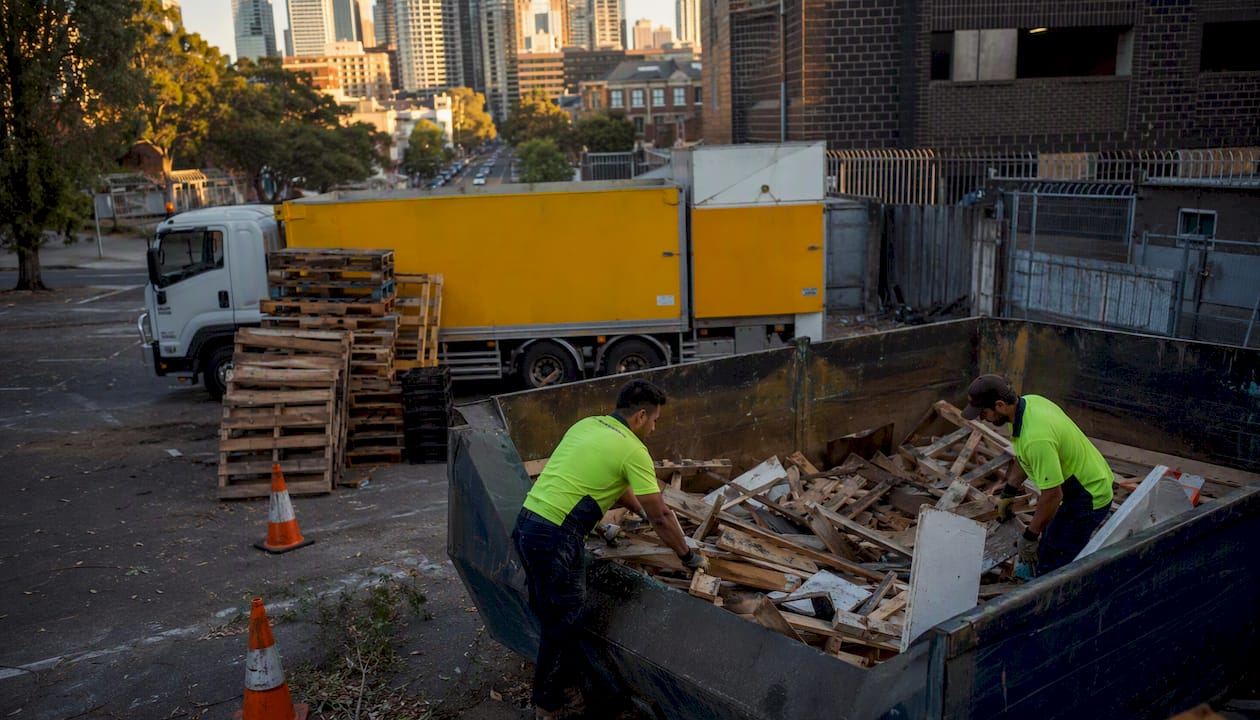 Workers loading commercial rubbish into truck