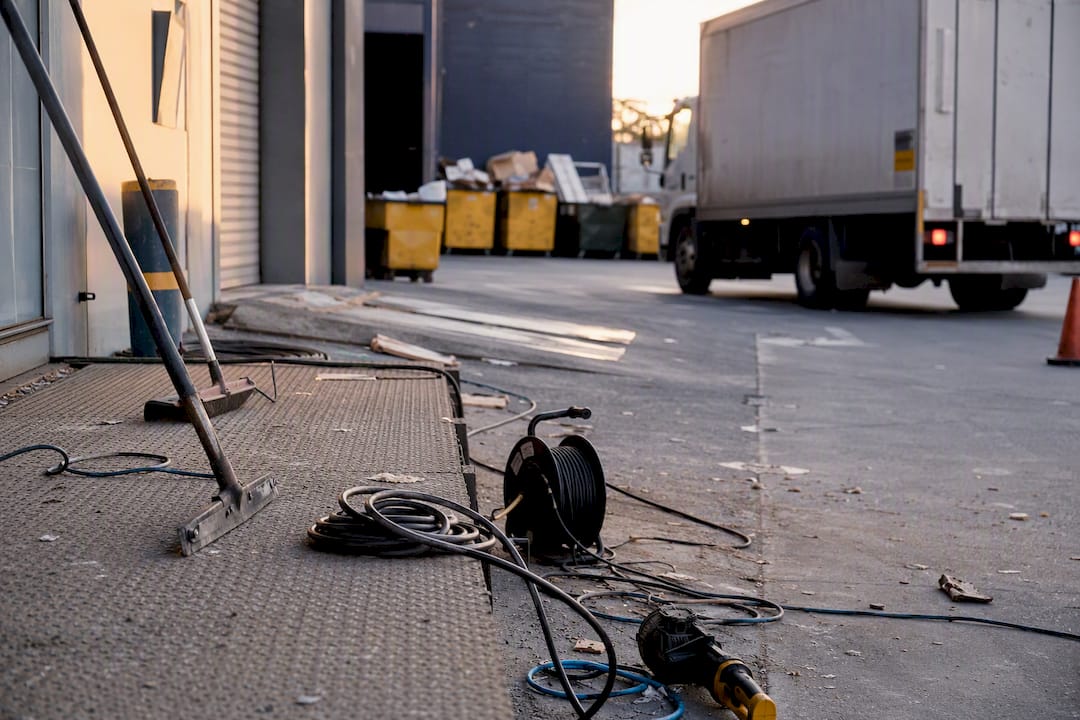 Commercial loading dock with rubbish removal truck and tools