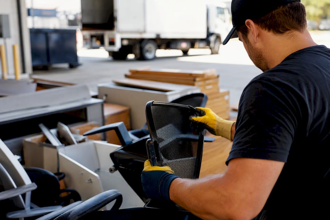Hands sorting office furniture for donation