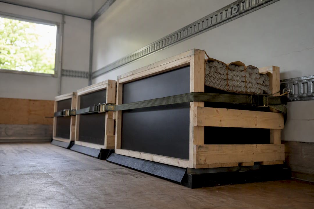 Crates holding fluorescent tubes in secure rubbish removal truck