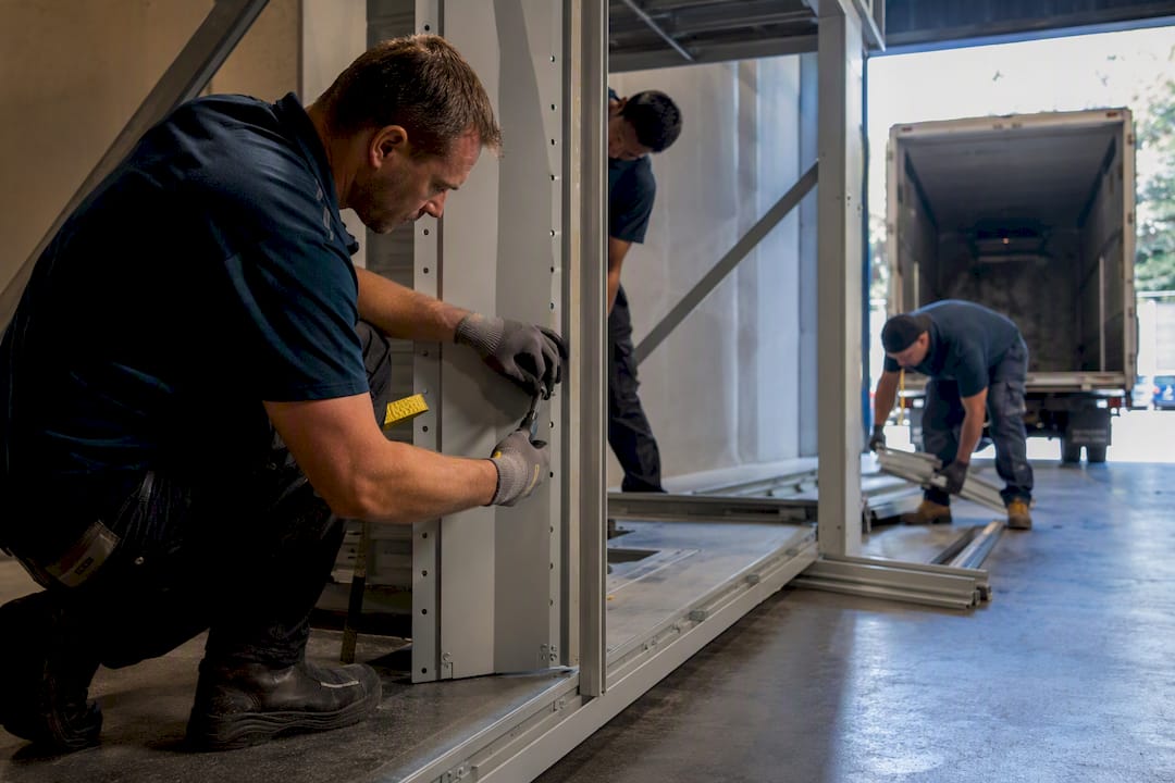 Crew dismantling compactus units for commercial removal