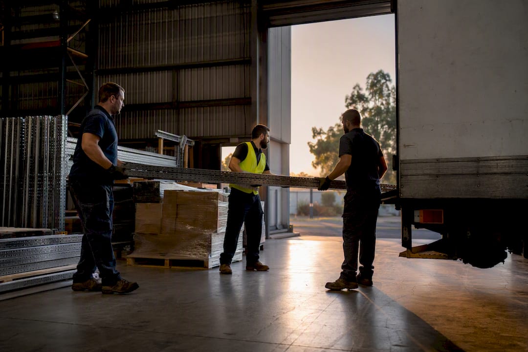 Warehouse crew loading commercial cleanout materials