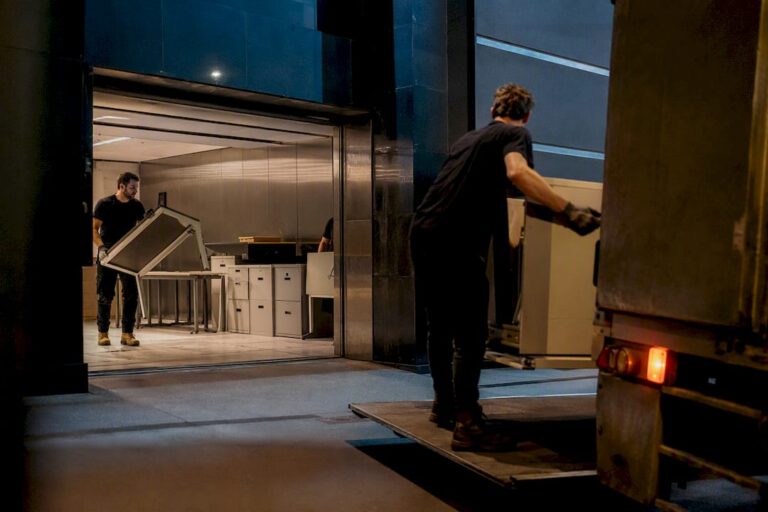 Commercial crew loading office furniture after dark