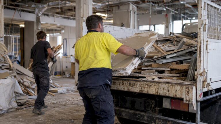 Crew loading sorted office demolition materials onto truck