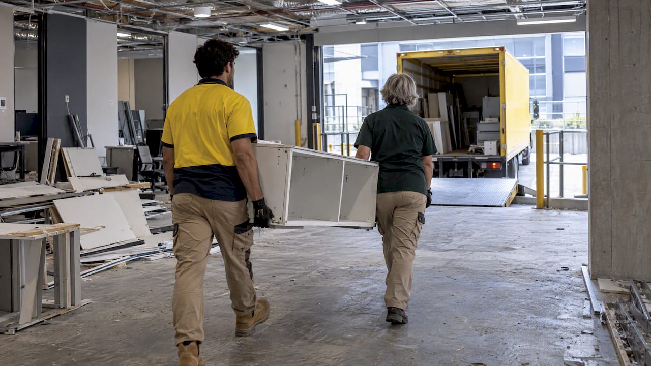 Office defit crew moving joinery toward truck